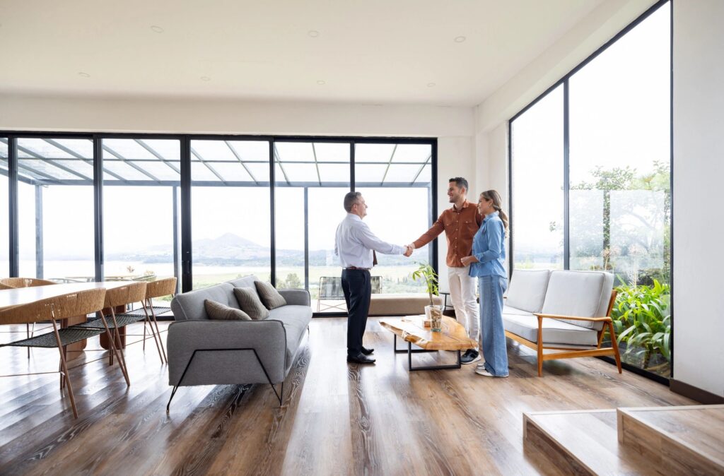 Real estate agent greeting a couple with a handshake